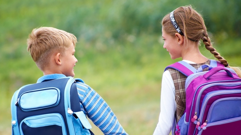 Children hold hands on the way to school. (YanLev / Shutterstock.com)