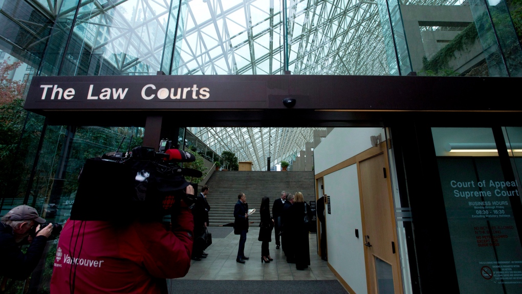 In this file image, people line up to be screened to enter the British Columbia Supreme Court in Vancouver, B.C. on Monday, Sept. 30, 2013. (Jonathan Hayward / THE CANADIAN PRESS)