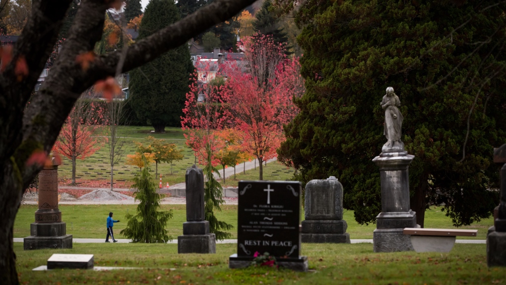 A man walks through Mountain View Cemetery in Vancouver, on Wednesday October 23, 2019. Vancouver council has approved changes that would allow strangers to share grave spaces in the name of being more environmentally friendly. THE CANADIAN PRESS/Darryl Dyck