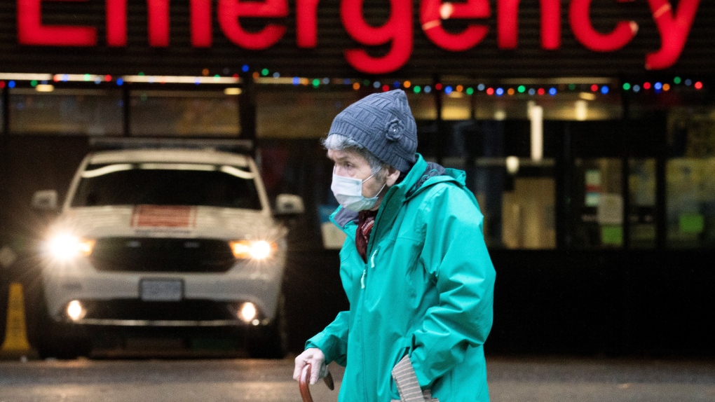 A woman wears a protective face mask to help prevent the spread of COVID-19 as they walk past the emergency department of the Vancouver General Hospital in Vancouver Wednesday, Nov. 18, 2020. (Jonathan Hayward / THE CANADIAN PRESS)