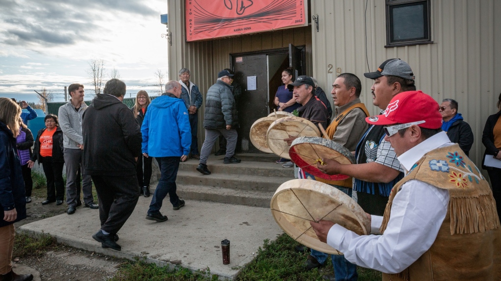 British Columbia Premier John Horgan (centre, blue jacket) is drummed into the Lower Post Residential School by Kaska drummers in Lower Post, B.C. on Orange Shirt Day in a 2019 handout photo (THE CANADIAN PRESS/HO-Manu Keggenhoff ).