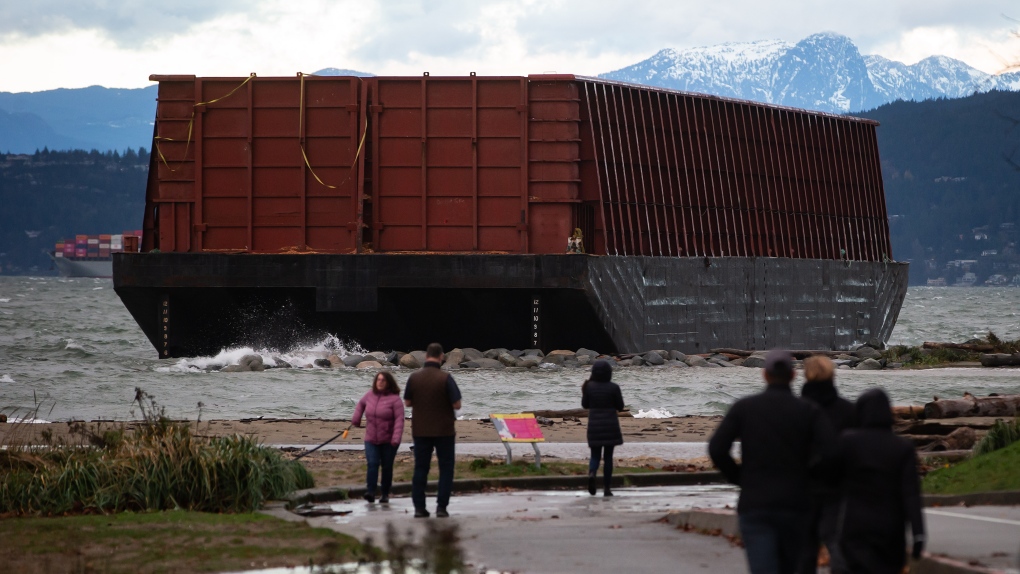 A barge that drifted loose on English Bay sits grounded on rocks during a massive windstorm in Vancouver, B.C., on Nov. 15, 2021. THE CANADIAN PRESS/Darryl Dyck 