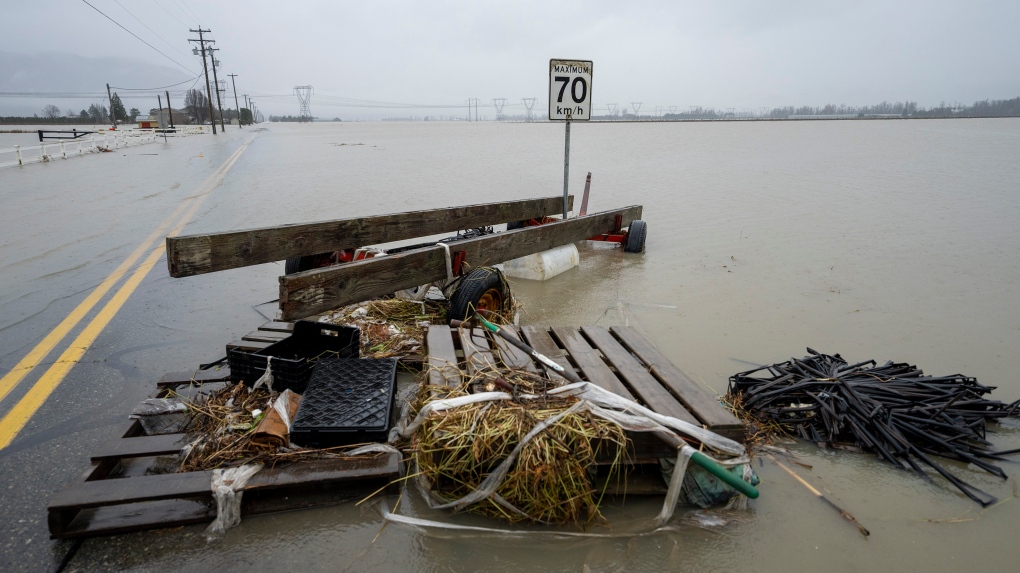 Debris is pictured along a flooded road in Abbotsford, B.C., Thursday, November 25, 2021. THE CANADIAN PRESS/Jonathan Hayward 
