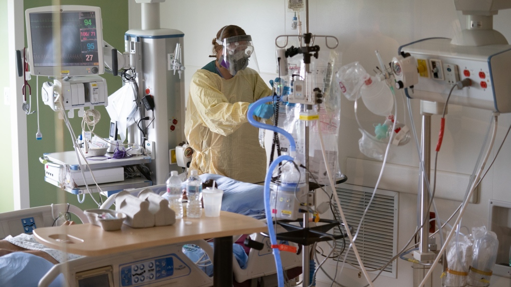A nurse attends to a patient in the COVID-19 Intensive Care Unit at Surrey Memorial Hospital in Surrey, B.C., Friday, June 4, 2021. (Jonathan Hayward / THE CANADIAN PRESS)