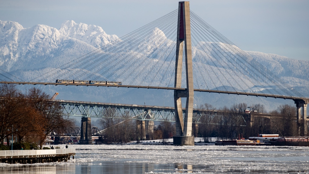 Ice floes are seen on the Fraser River as a Skytrain crosses over the river in New Westminster, B.C., on Tuesday, December 28, 2021. 