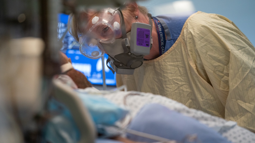 Registered nurse Linda Wright speaks to a patient in the COVID-19 Intensive Care Unit at Surrey Memorial Hospital in Surrey, B.C., Friday, June 4, 2021. THE CANADIAN PRESS/Jonathan Hayward 
