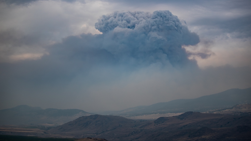 A pyrocumulus cloud, also known as a fire cloud, forms in the sky as the Tremont Creek wildfire burns on the mountains above Ashcroft, B.C., on Friday, July 16, 2021. THE CANADIAN PRESS/Darryl Dyck 