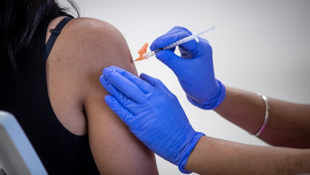 A woman receives her first dose of the Pfizer COVID-19 vaccine at an immunization clinic at the Gurdwara Dukh Nivaran Sahib, in Surrey, B.C., on Friday, May 14, 2021. THE CANADIAN PRESS/Darryl Dyck 