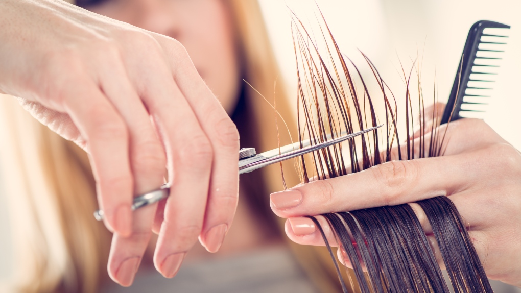 A stylist cuts a person's hair in this undated stock image. (Shutterstock)