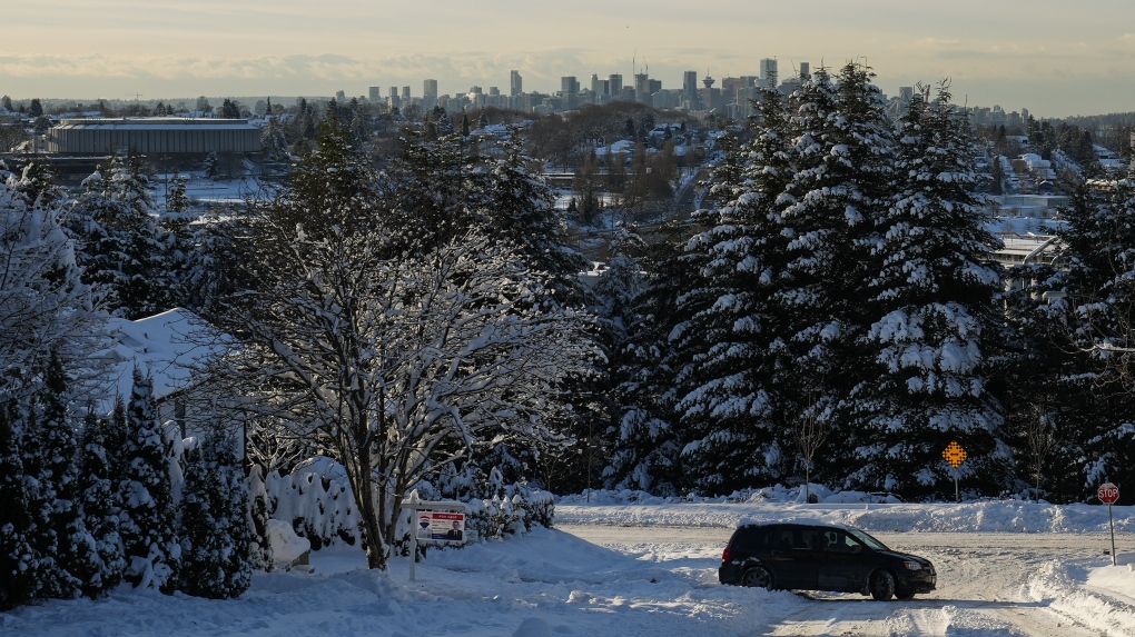 A motorist turns around after attempting to drive up a snow and ice covered hill in Vancouver, on Wednesday, Dec. 21, 2022. THE CANADIAN PRESS/Darryl Dyck