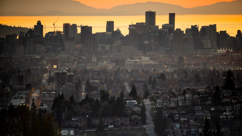 The downtown Vancouver skyline is seen at sunset, as houses line a hillside in Burnaby, B.C., on Saturday, April 17, 2021. (Darryl Dyck / THE CANADIAN PRESS)