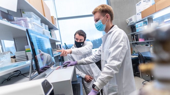 Connor Thompson, left, seen with researcher Annika Schulz, is co-author of a study on the use of a nasal spray for preventing and treating COVID-19 infection. (Credit: UBC/Paul Joseph)