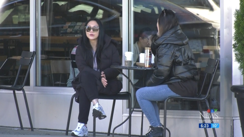 Two people are seen enjoying beverages outside a Vancouver Starbucks. On Feb. 15, 2023 city council voted in favour of scrapping a single-use cup fee that was introduced last January. (CTV)