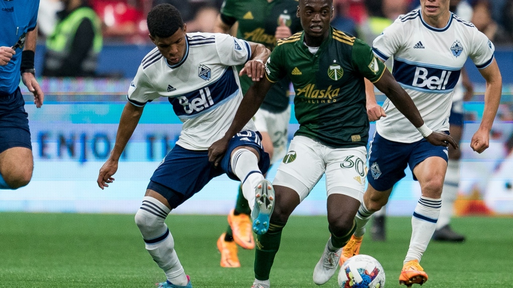 Vancouver Whitecaps midfielder Pedro Vite (45) and Portland Timbers midfielder Santiago Moreno (30) battle for control of the ball during second half MLS soccer action in Vancouver on Saturday, April 9, 2022. THE CANADIAN PRESS/Rich Lam