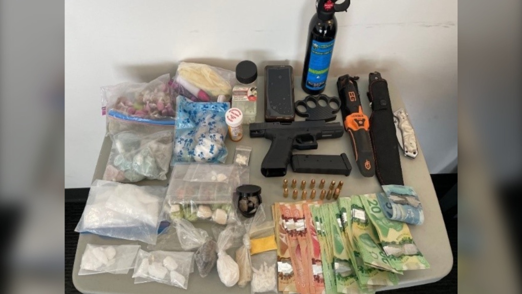 Mounties in Surrey say a man fled from officers during a traffic stop late last month. When they caught up with him the following day, he was carrying a handgun, four kinds of drugs and more than $1,400 in cash. (Surrey RCMP)