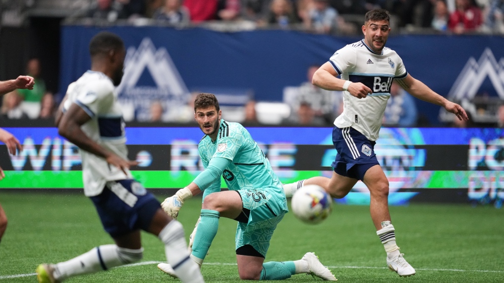 Toronto FC goalkeeper Alex Bono, centre, watches as Vancouver Whitecaps' Tosaint Ricketts, front left, scores after receiving a pass from Lucas Cavallini, back right, during the second half of an MLS soccer game in Vancouver, B.C., Sunday, May 8, 2022. THE CANADIAN PRESS/Darryl Dyck9