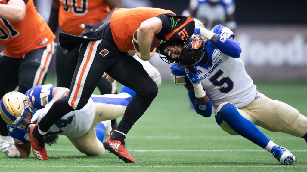 B.C. Lions quarterback Nathan Rourke (12) is sacked by Winnipeg Blue Bombers' Willie Jefferson (5) during the first half of CFL football game in Vancouver, on Saturday, July 9, 2022. THE CANADIAN PRESS/Darryl Dyck