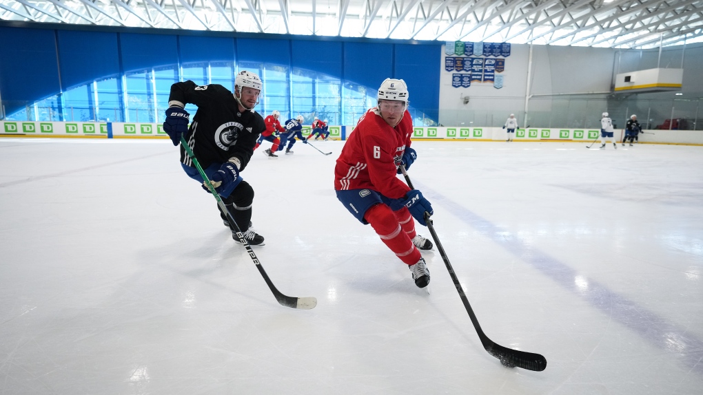 Vancouver Canucks' Brock Boeser, right, tries to keep the puck away from Oliver Ekman-Larsson, of Sweden, during the NHL hockey team's training camp in Whistler, B.C., Thursday, Sept. 22, 2022. THE CANADIAN PRESS/Darryl Dyck