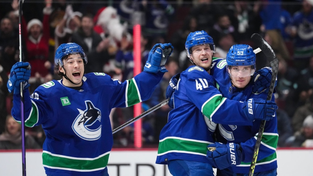 Vancouver Canucks' Andrei Kuzmenko, of Russia, from left to right, Elias Pettersson, of Sweden, and Bo Horvat celebrate Pettersson's tying goal against the Seattle Kraken during the third period of an NHL hockey game in Vancouver, on Thursday, December 22, 2022.&nbsp;Elias Pettersson has one hope for Vancouver Canucks fans as ex-captain Bo Horvat makes his return to Rogers Arena on Wednesday. THE CANADIAN PRESS/Darryl Dyck