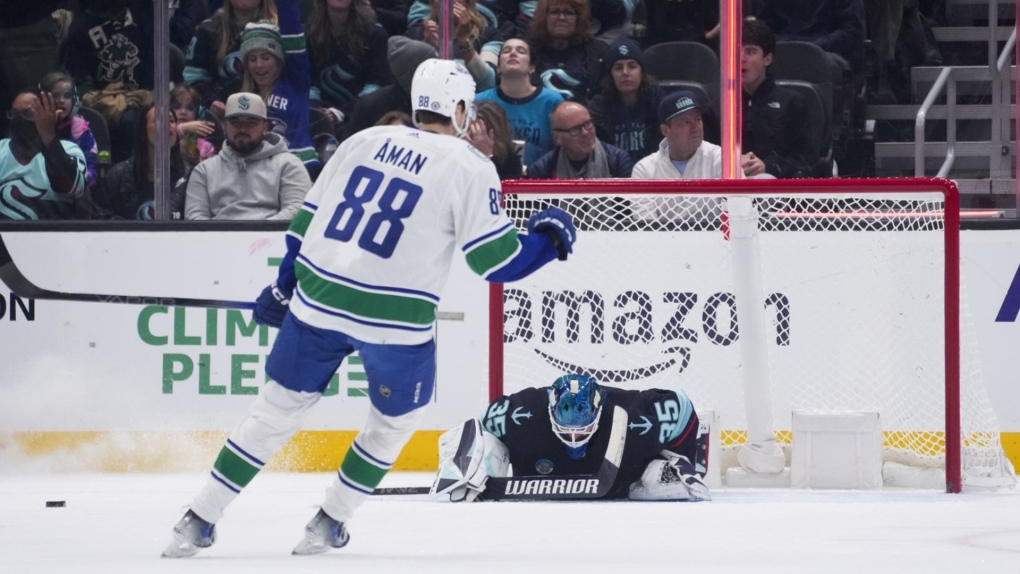 Seattle Kraken goaltender Joey Daccord looks down after allowing a goal to Vancouver Canucks centre Teddy Blueger, as centre Nils Aman (88) reacts during the first period of an NHL hockey game Friday, Nov. 24, 2023, in Seattle. (AP Photo/Lindsey Wasson)