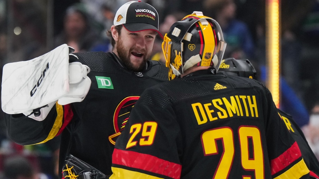 Vancouver Canucks goalie Thatcher Demko, back left, congratulates starting goalie Casey DeSmith (29) on his shutout during Vancouver's 2-0 win against the Minnesota Wild during an NHL hockey game in Vancouver, on Thursday, December 7, 2023. THE CANADIAN PRESS/Darryl Dyck