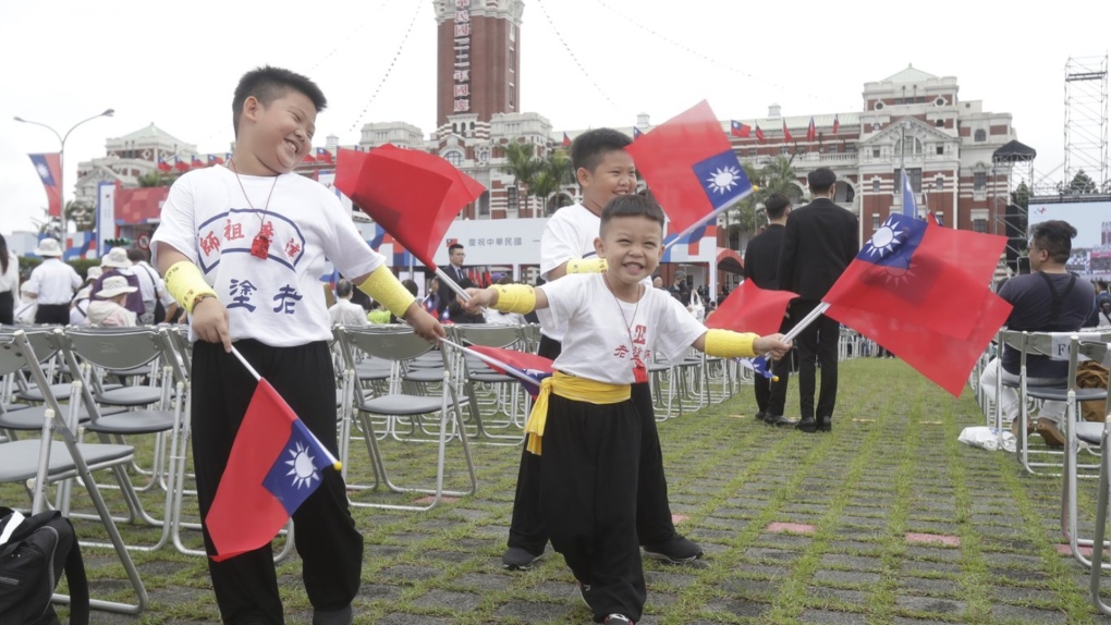 Taiwan is enjoying a spike in prominence in Canadian discourse in the past year, which experts attribute to several geopolitical reasons. Children wave Taiwan's national flags during National Day celebrations in front of the Presidential Building in Taipei, Taiwan, Tuesday, Oct. 10, 2023. THE CANADIAN PRESS/AP-Chiang Ying-ying