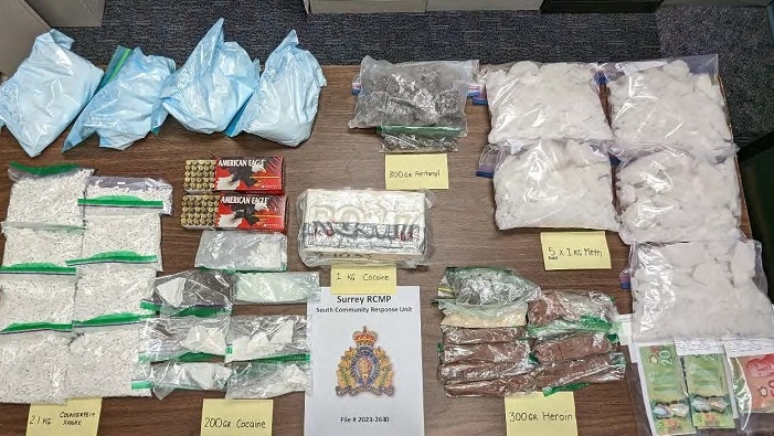 A search warrant executed at a Surrey business allegedly being used as "a front for drug trafficking" led to the seizure of thousands of potentially fatal doses of illicit drugs, according to Mounties.
