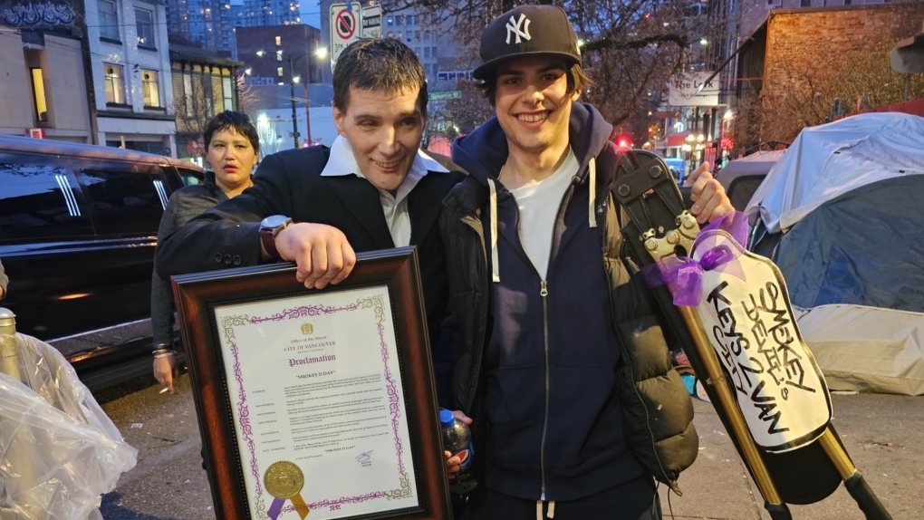 James Hardy, the graffiti artist known as Smokey Devil, stands with his son on the Vancouver's Downtown Eastside, after attending a proclamation by the City of Vancouver, declaring March 11, 2023 as Smokey D. Day. (Twitter, Sarah Blyth-Gerszak)