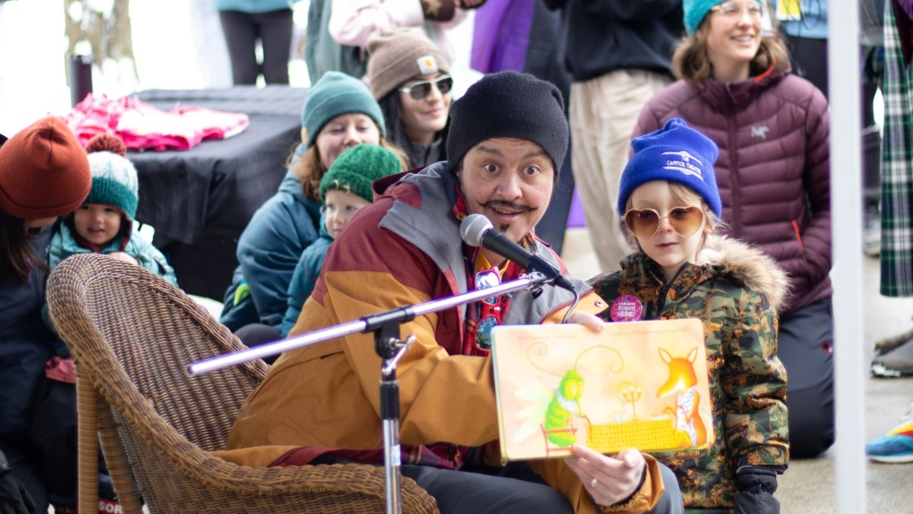 Birkley Valks reads a story at a peaceful event held outside Nelson City Hall on March 11, the same day a drag storytime event for children was supposed to be held at Nelson Public Library, but was cancelled over safety concerns. (Credit: Ryan B. and DaMo Photography)