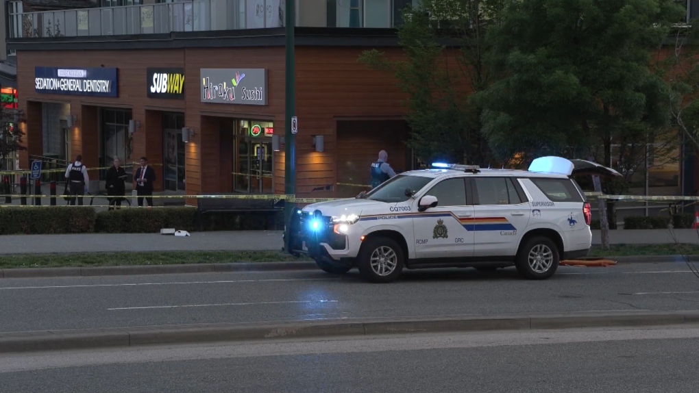 A Coquitlam RCMP vehicle surrounds a shopping centre complex where a shooting took place around 7:30 p.m., Wednesday, May 17, 2023. One person has been taken to hospital with life-threatening injuries, and Mounties believe a vehicle fire that was reported shortly after what they're calling a targeted shooting may be linked. (CTV)