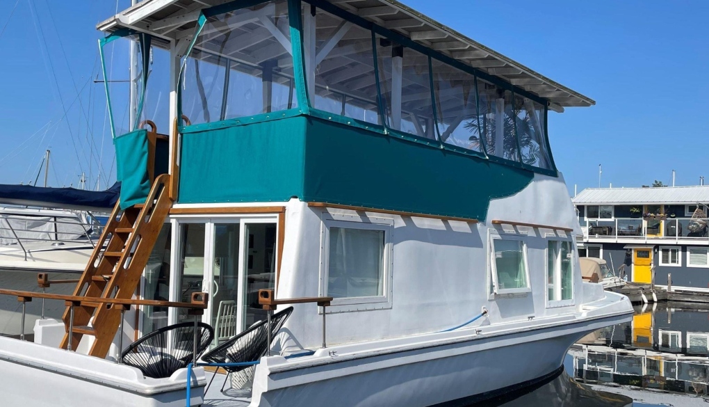 This photo shows the exterior of a boat that has been converted into a float home. (Image credit: teamtaylorrealty.ca)
