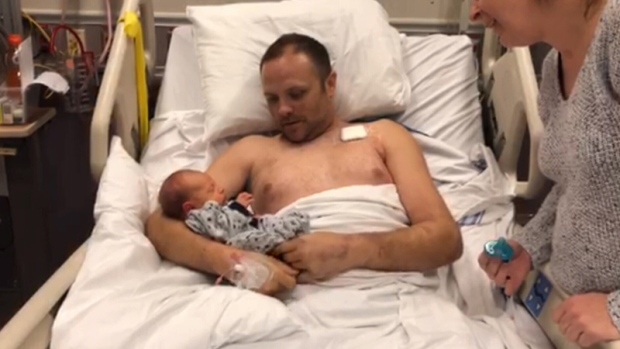 Father meets new baby for the first time
